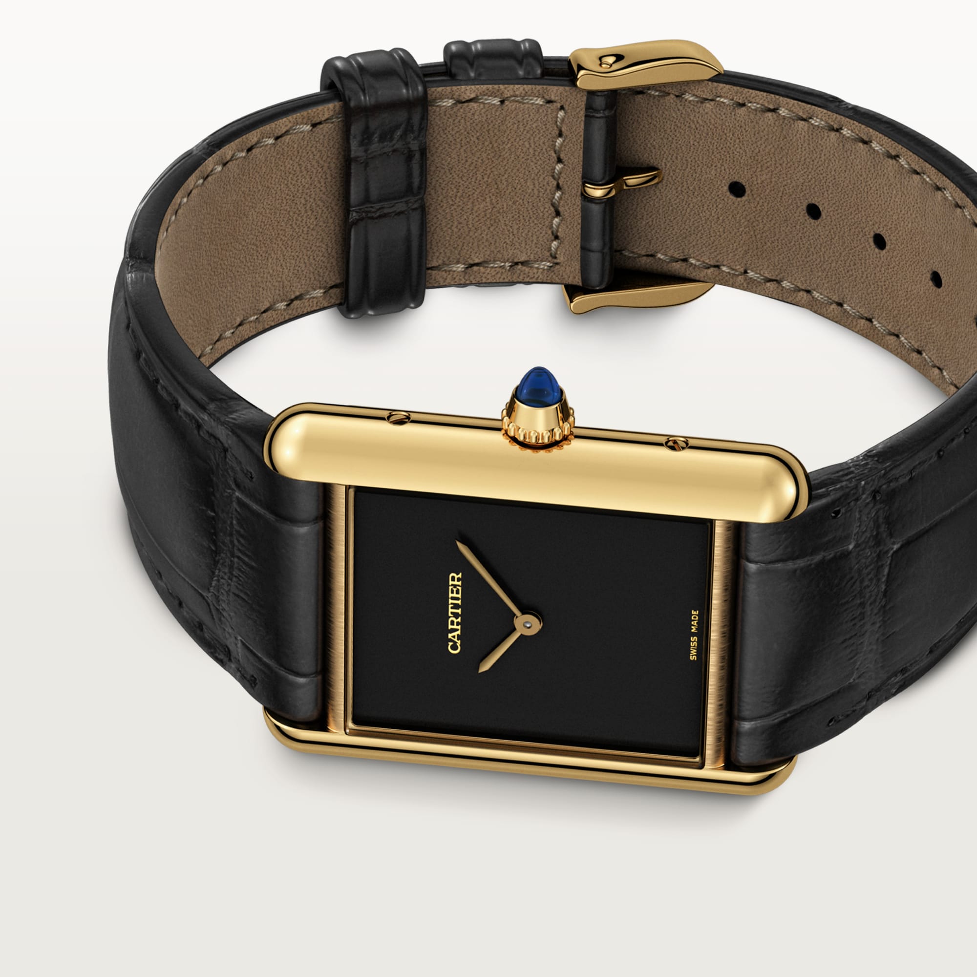 Angled view of a Dupe Tank Louis Cartier large model watch, a classic combination of a yellow gold color case, black dial, and black leather strap.