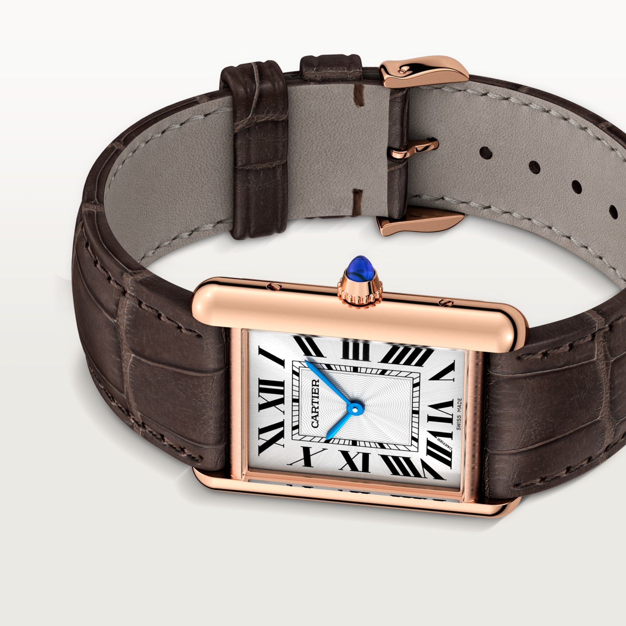 Angled view of a Dupe Tank Louis Cartier large model watch, an elegant combination of a rose gold color case and dark brown leather strap.