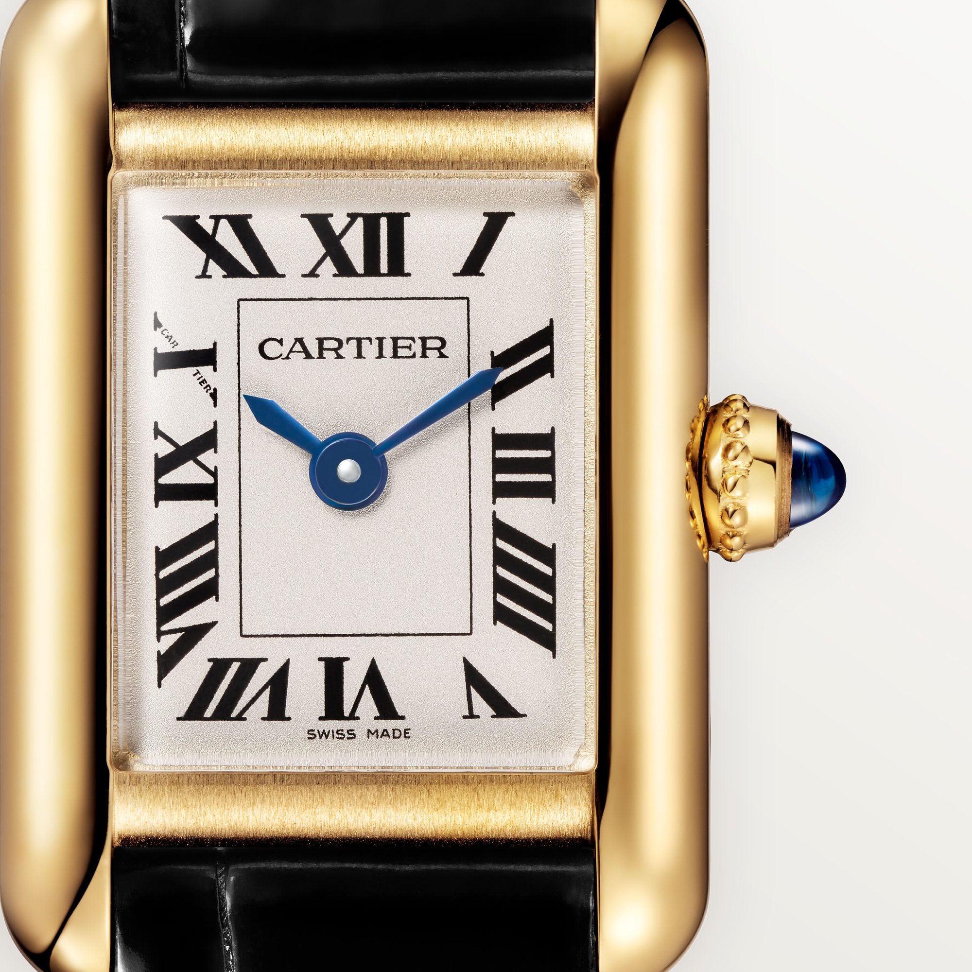 Macro shot: Dial of Dupe Tank Louis Cartier mini model watch, yellow gold colors case, with Roman numerals, blue hands, and blue spinel crown.