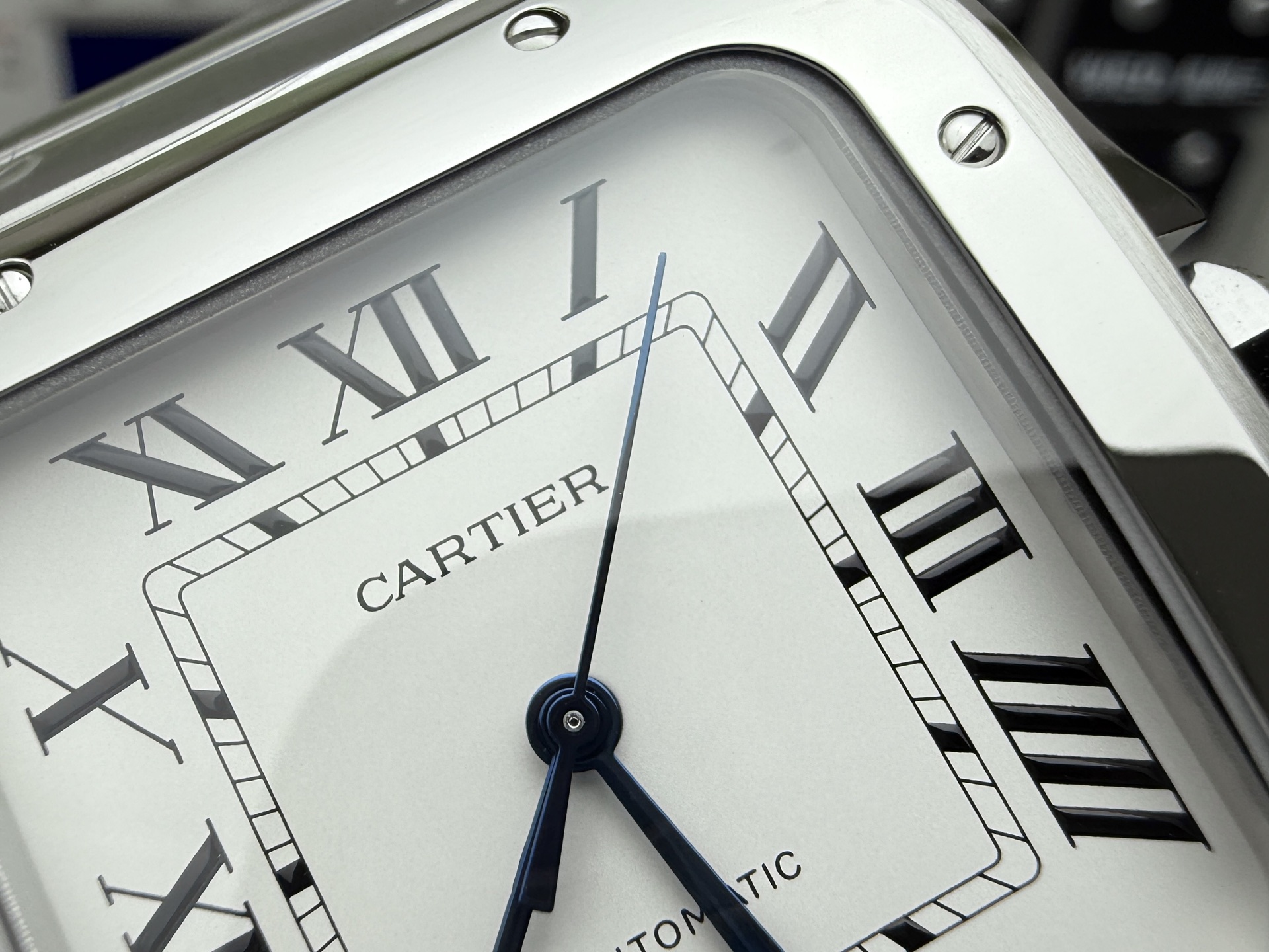 Top close-up of the dial of the BVF Super Clone Cartier Santos replica watch, featuring a silver dial with Roman numerals and the
