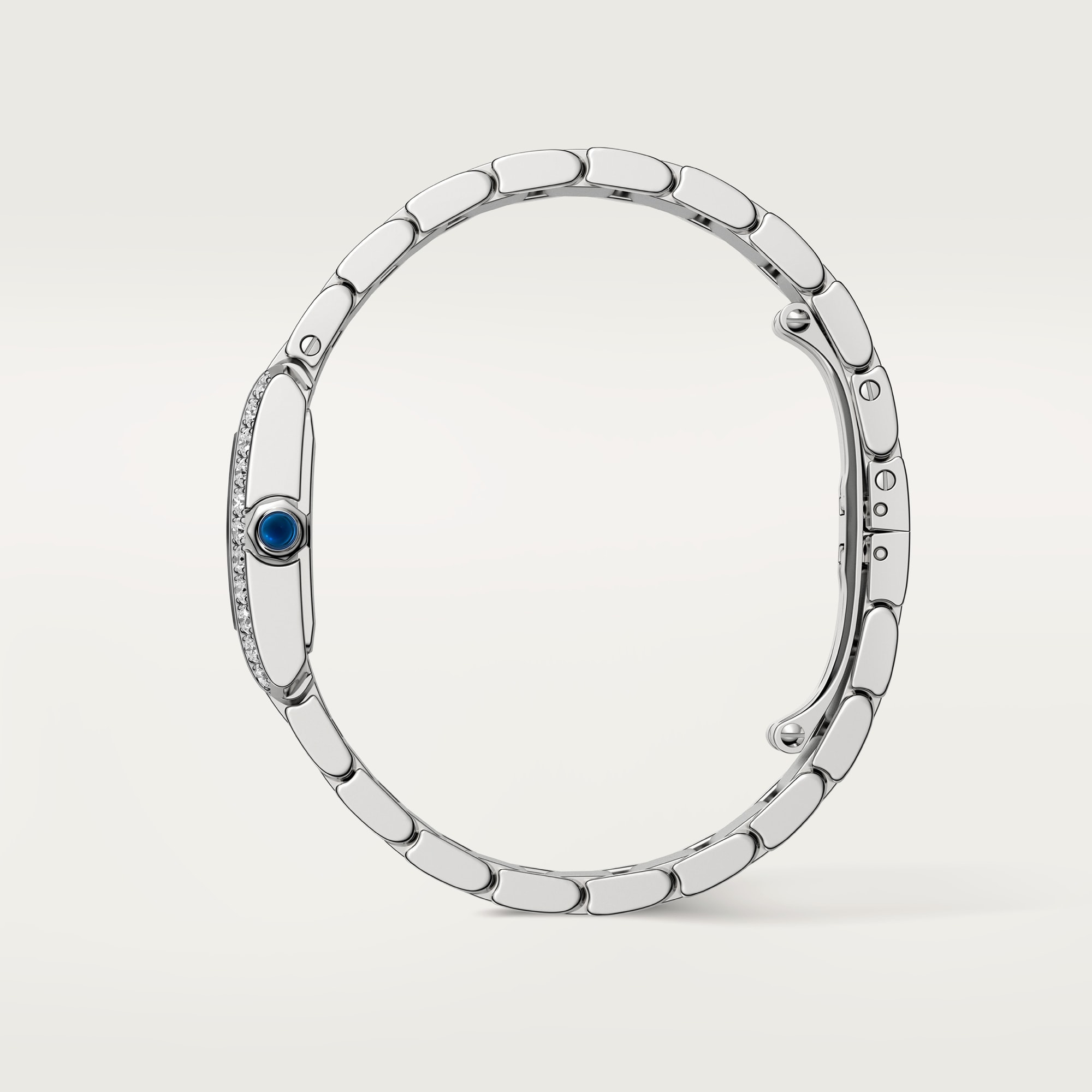 Side profile of a Dupe Tank Française small model watch, showing the steel case thickness and the crown set with a blue spinel.