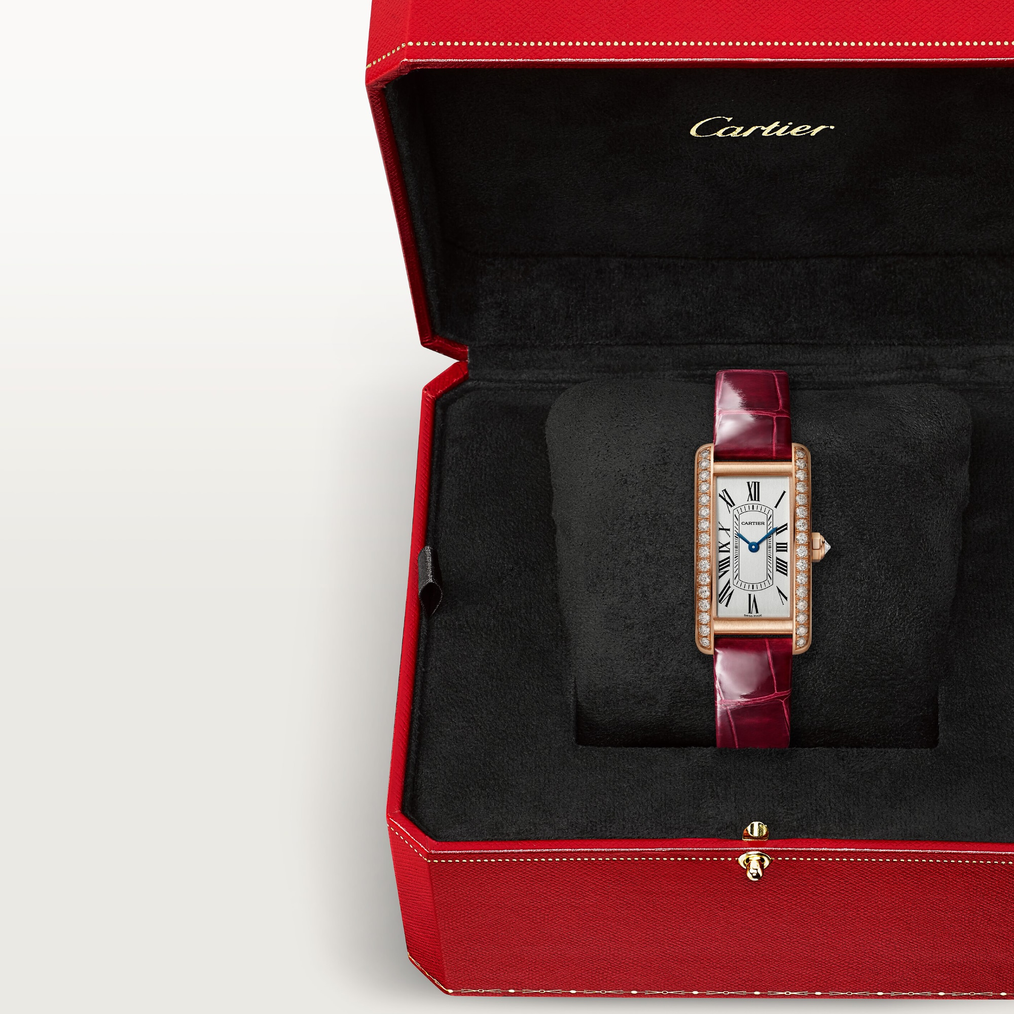 In box: Dupe Tank Américaine small model rose gold diamond watch with burgundy patent leather strap, presented in its iconic red brand packaging.