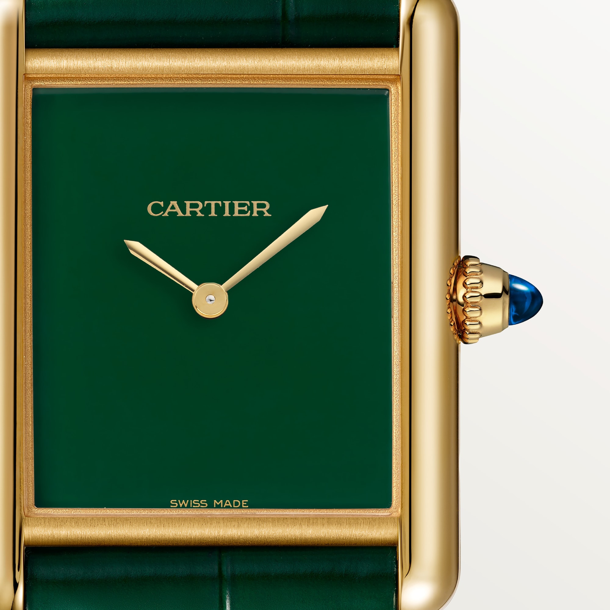Macro shot of the green dial on a Dupe Tank Louis Cartier large model watch with a yellow gold colors case, showing gold hands and blue spinel crown.