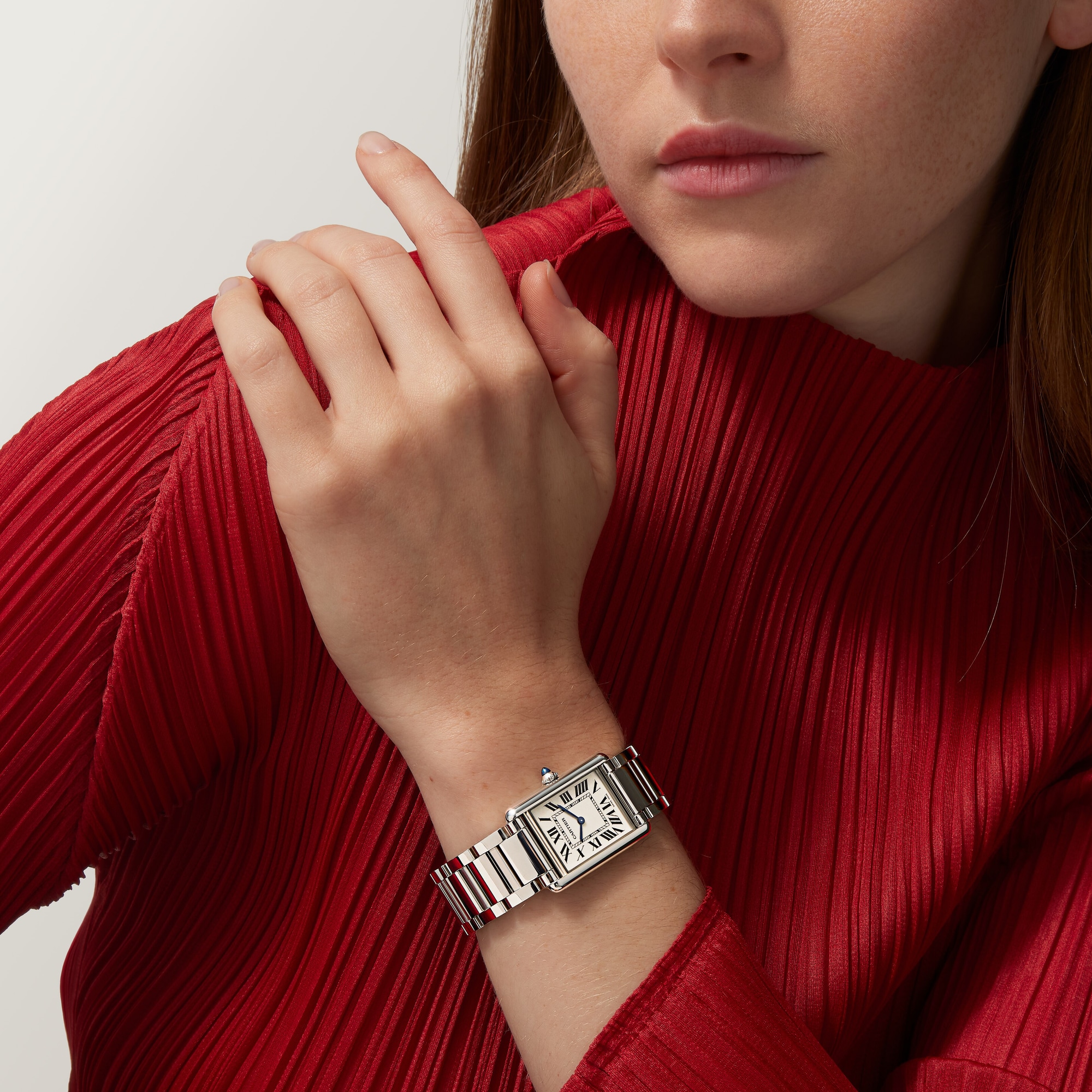 Woman's wrist showcasing the small Tank Must Solarbeat™ dupe Cartier watch with a full steel case and bracelet.