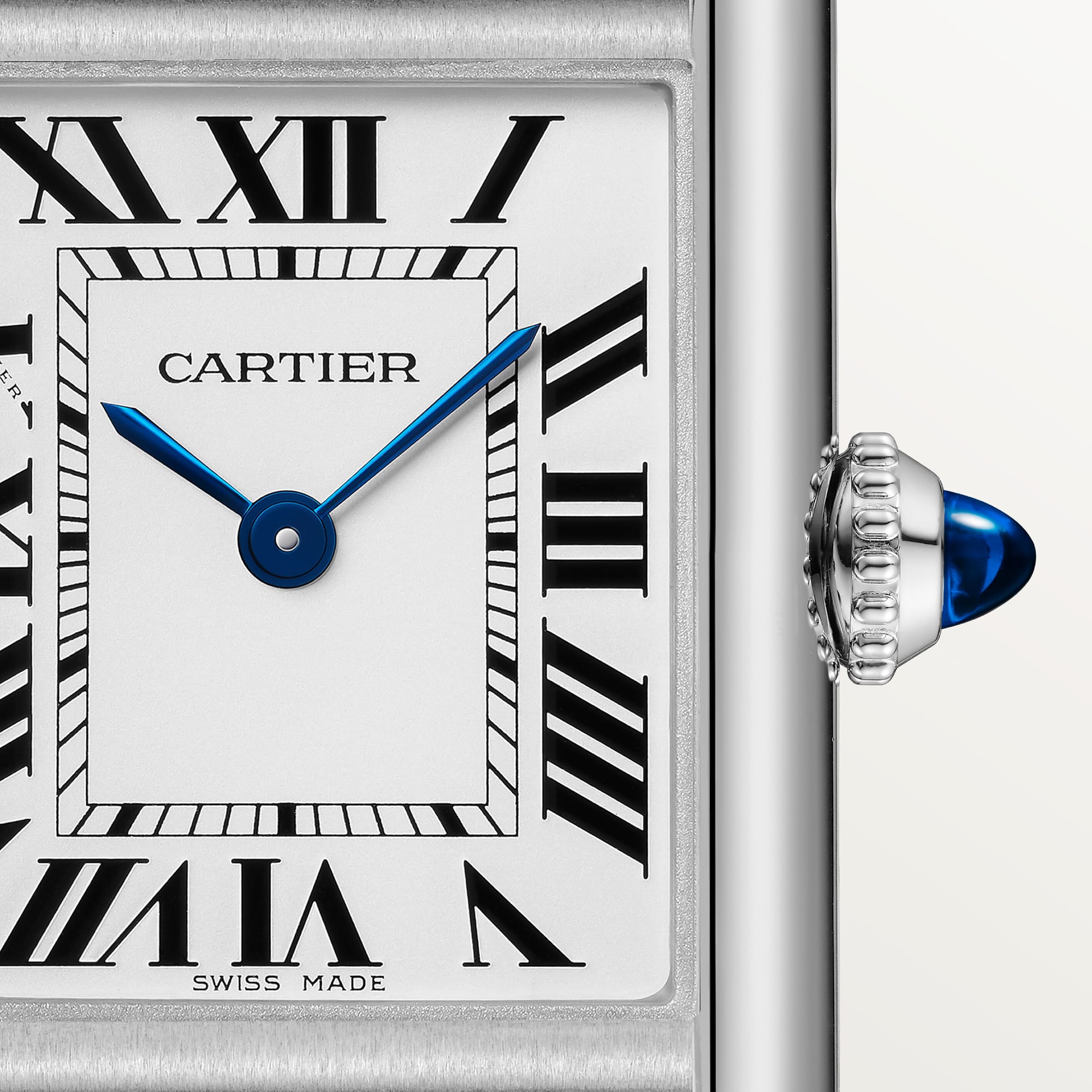 Detailed close-up of the white Roman numeral dial on a small Tank Must Solarbeat™ dupe Cartier watch, steel case, blue hands.
