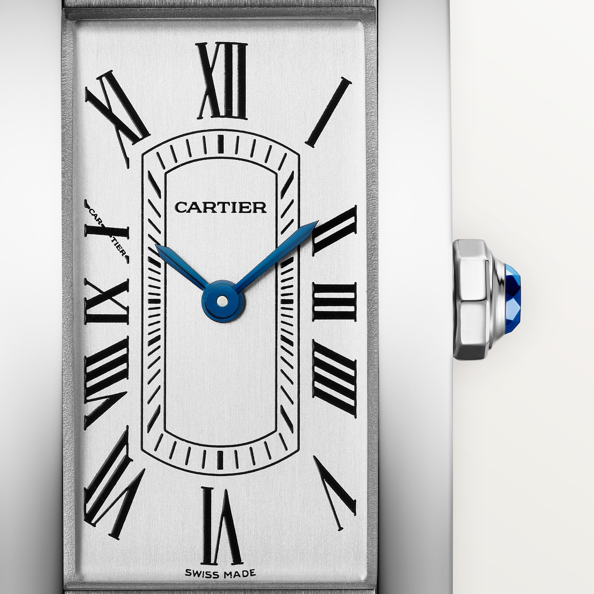 Detailed close-up of the silver Roman numeral dial on a small Tank Américaine dupe Cartier watch, steel case, with blue hands.