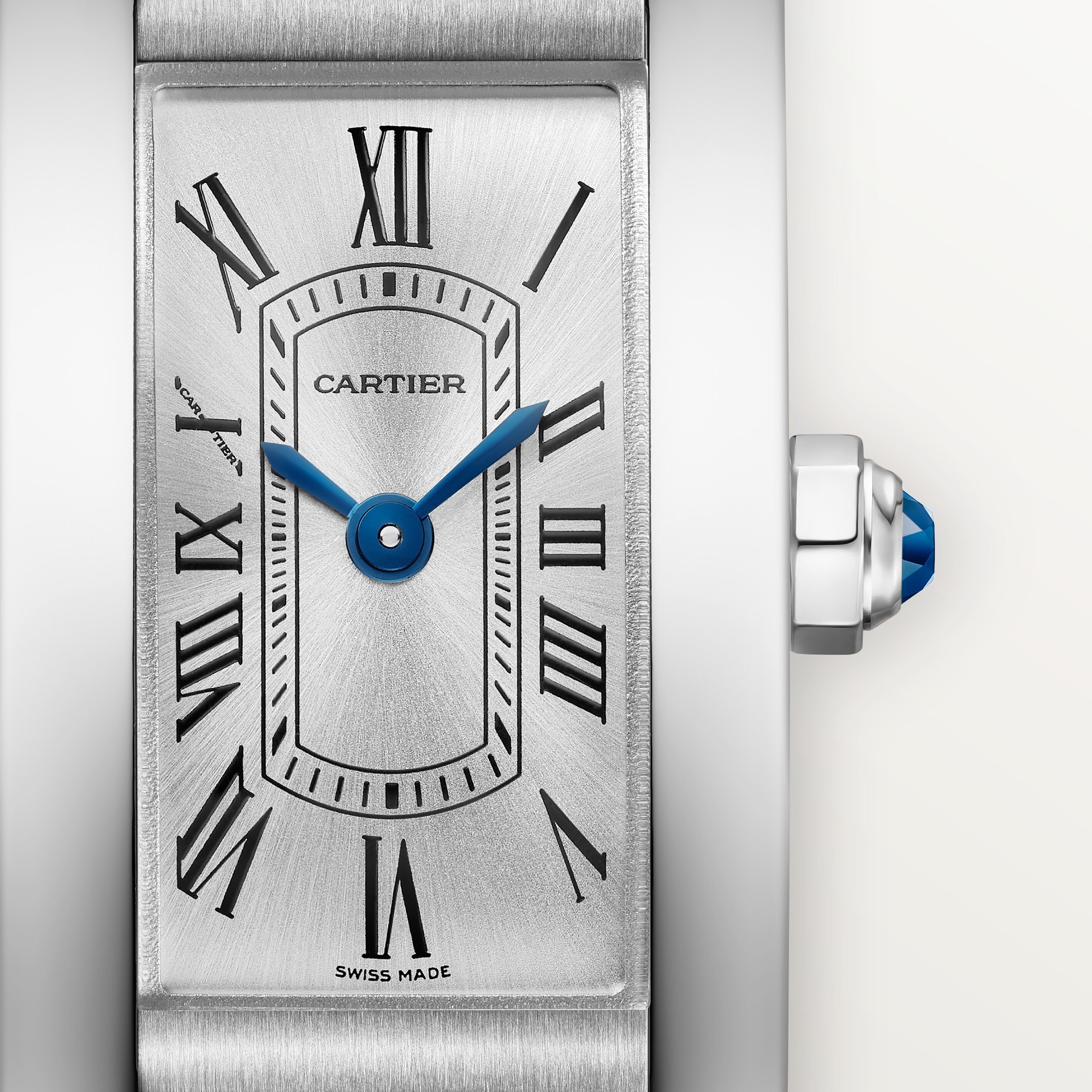 Detailed close-up of the silver Roman numeral dial on a mini Tank Américaine dupe Cartier watch, steel case, with blue hands.