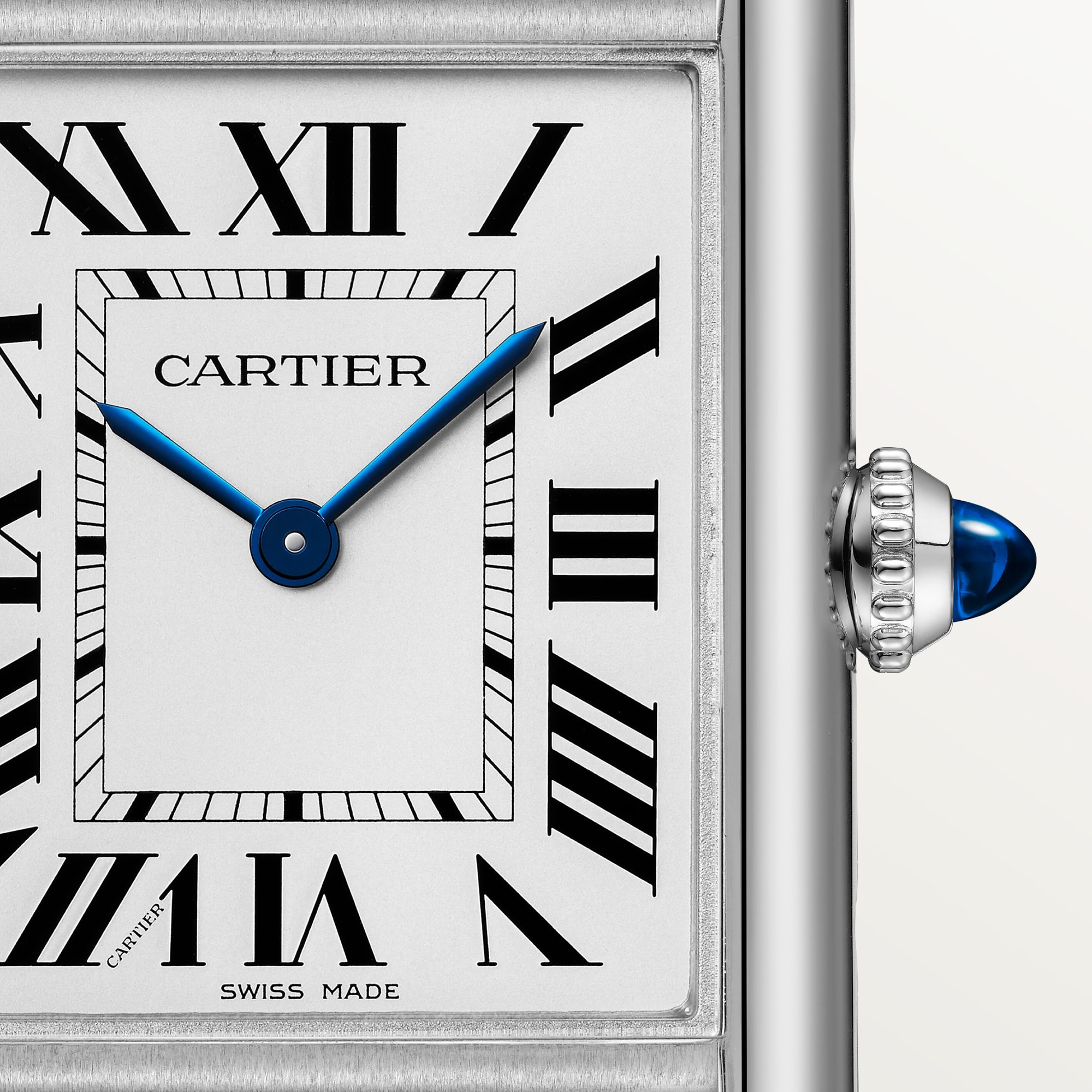 Detailed close-up of the white Roman numeral dial on a large Tank Must Solarbeat™ dupe Cartier watch, steel case, with blue hands.