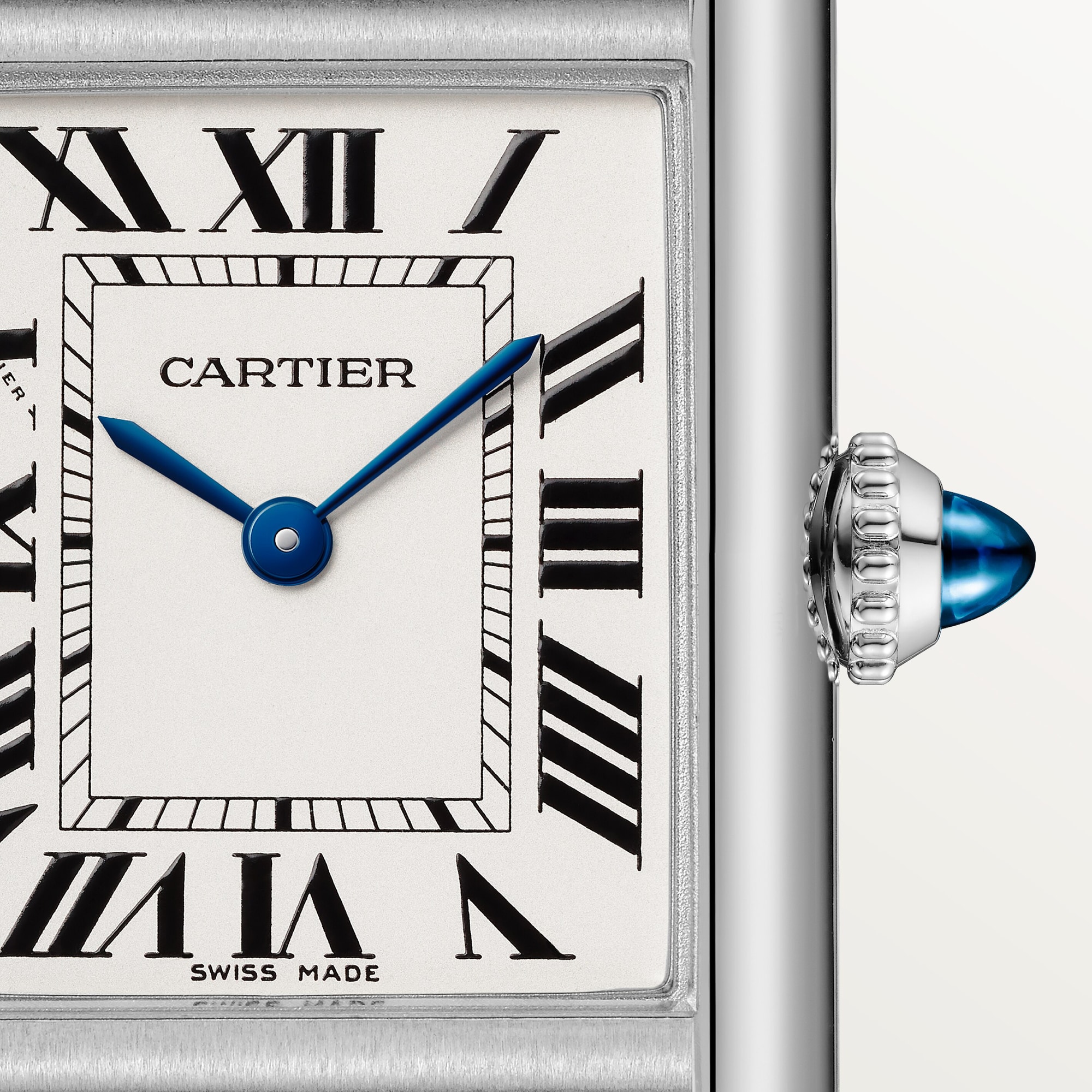 Close-up of the dial on a small Tank Must dupe Cartier watch in steel, featuring Roman numerals and blue hands.