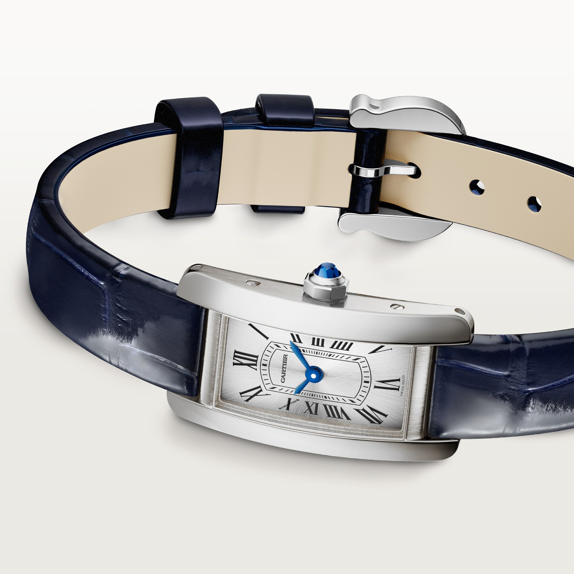Angled view of a mini Tank Américaine dupe Cartier watch: steel case, silver Roman dial, blue hands, and navy blue leather strap.