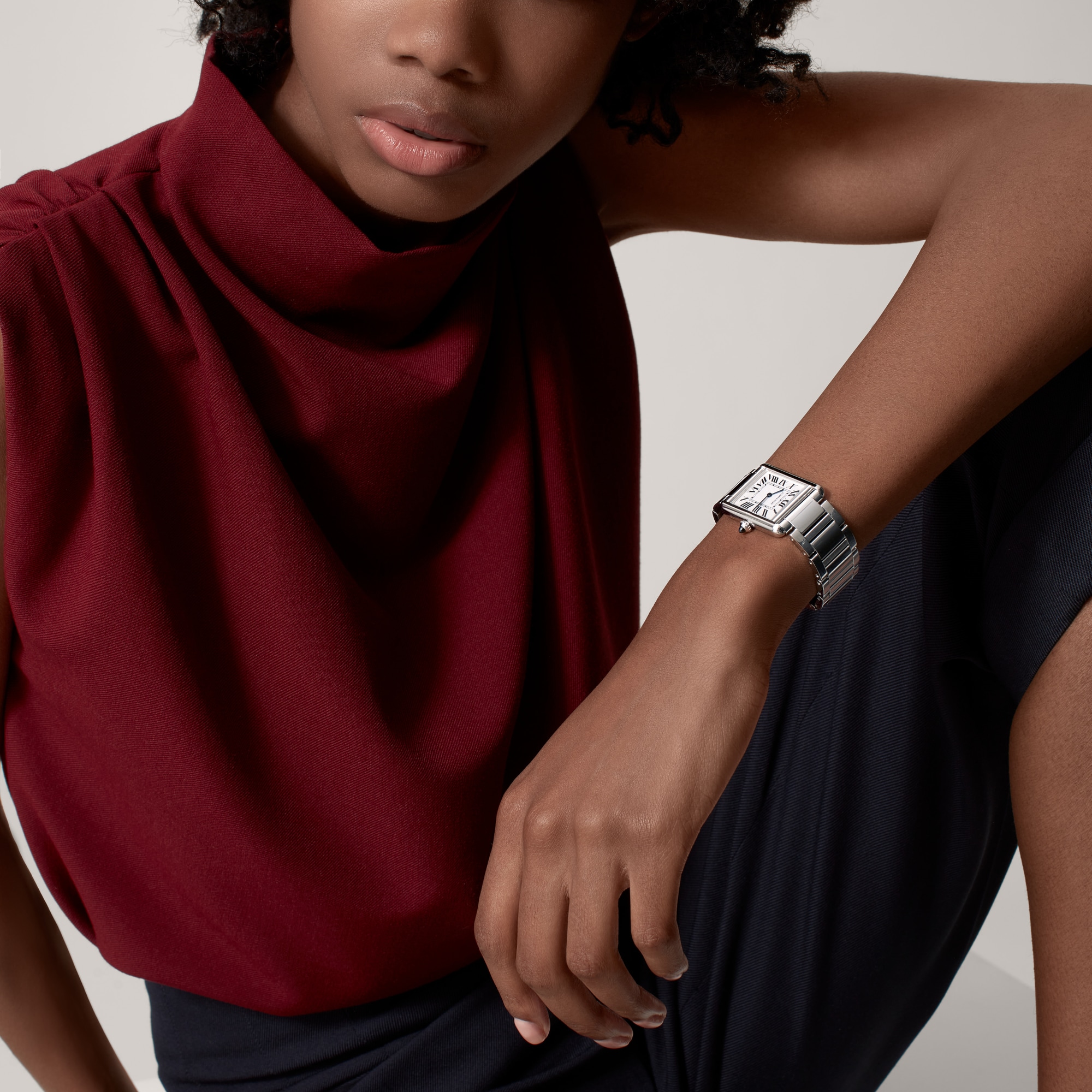 Lifestyle image featuring a person wearing the large steel Tank Must dupe Cartier watch for an elegant look.