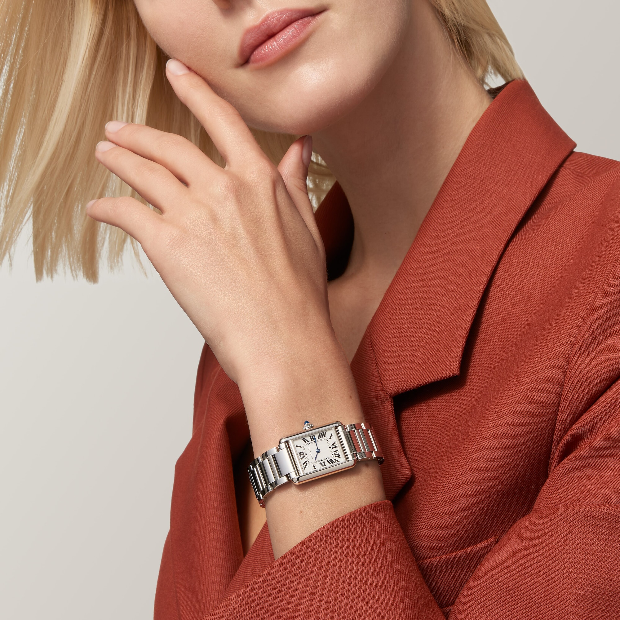 Woman's wrist showcasing the small Tank Must Solarbeat™ dupe Cartier watch with a steel case and bracelet