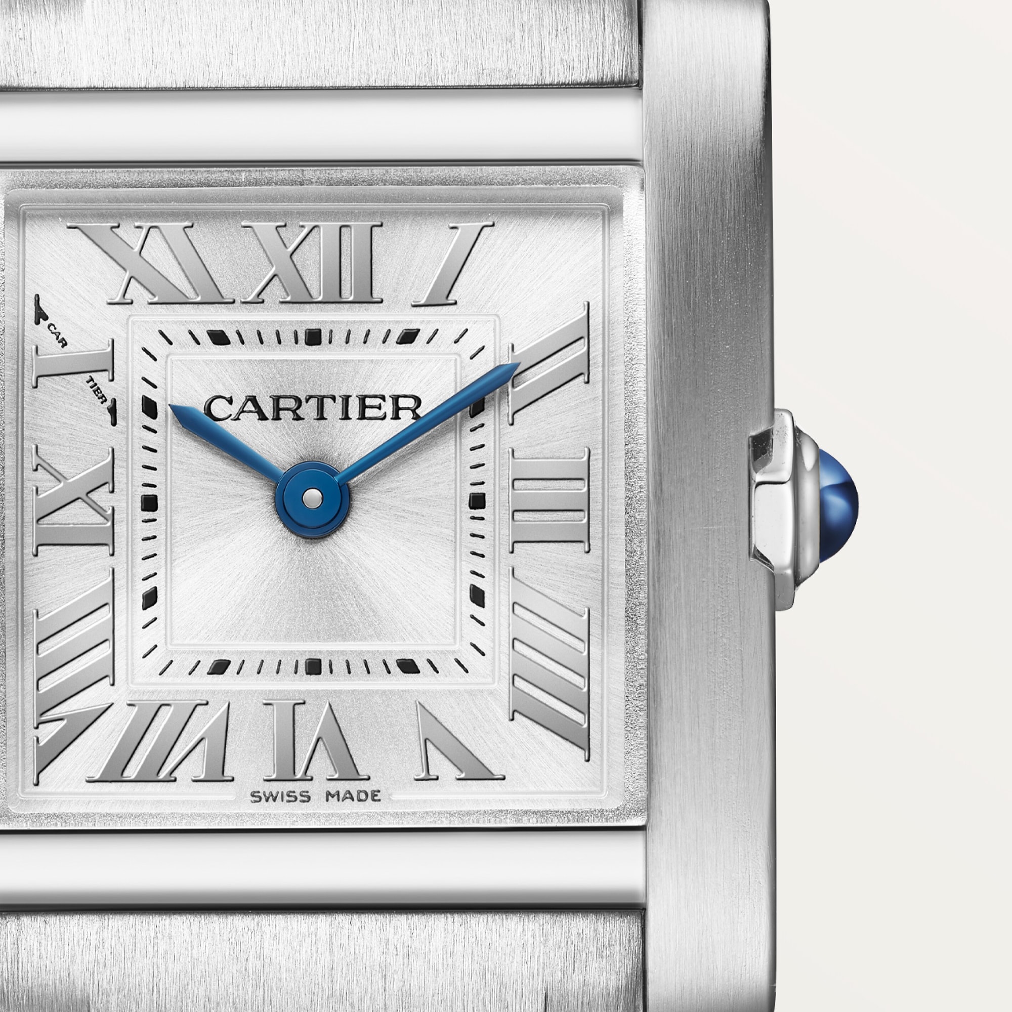Close-up of the silver Roman numeral dial on a small Tank Française dupe Cartier watch, steel case, with blue hands.
