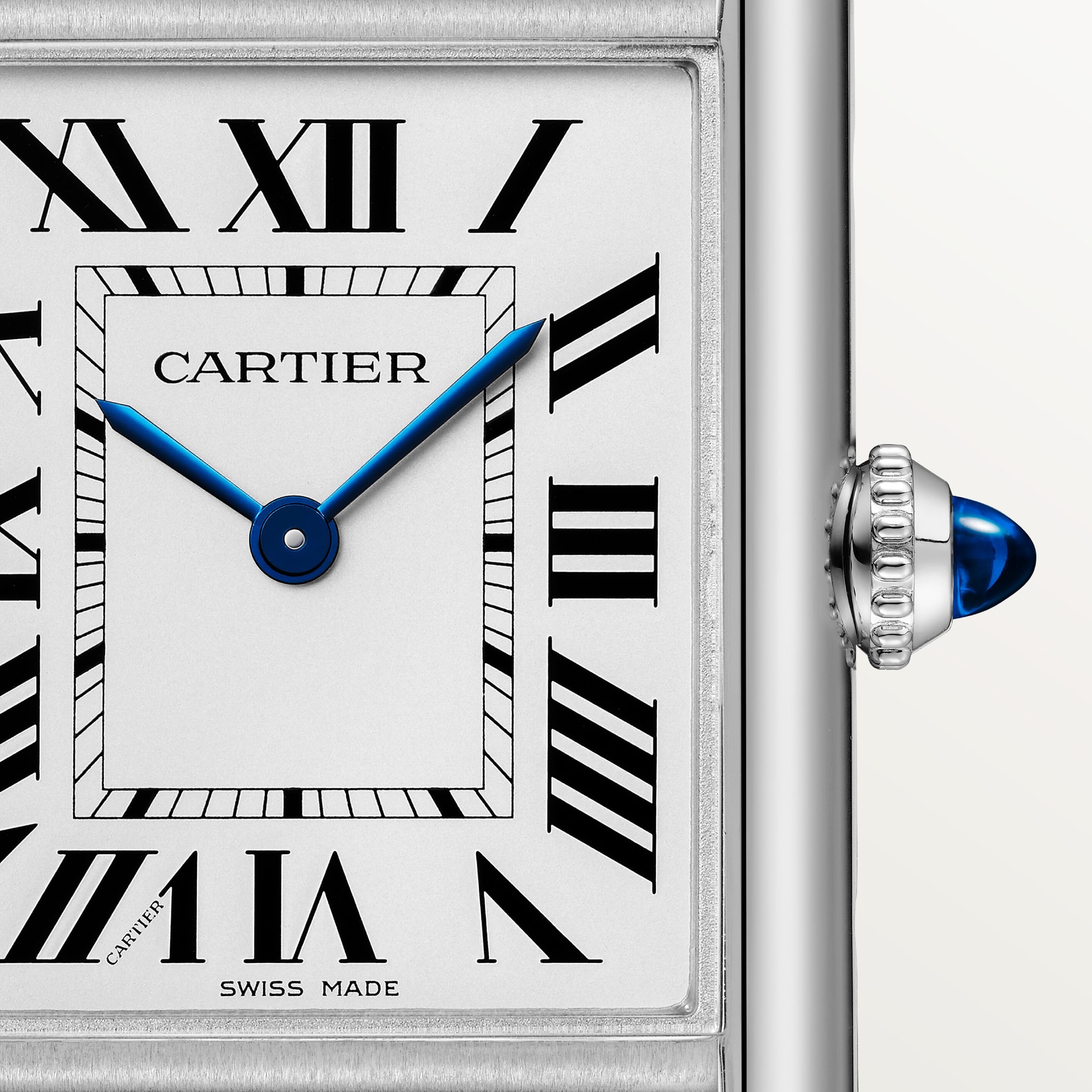 Detailed close-up of the white Roman numeral dial on a small Tank Must Solarbeat™ dupe Cartier watch, steel case, blue hands.
