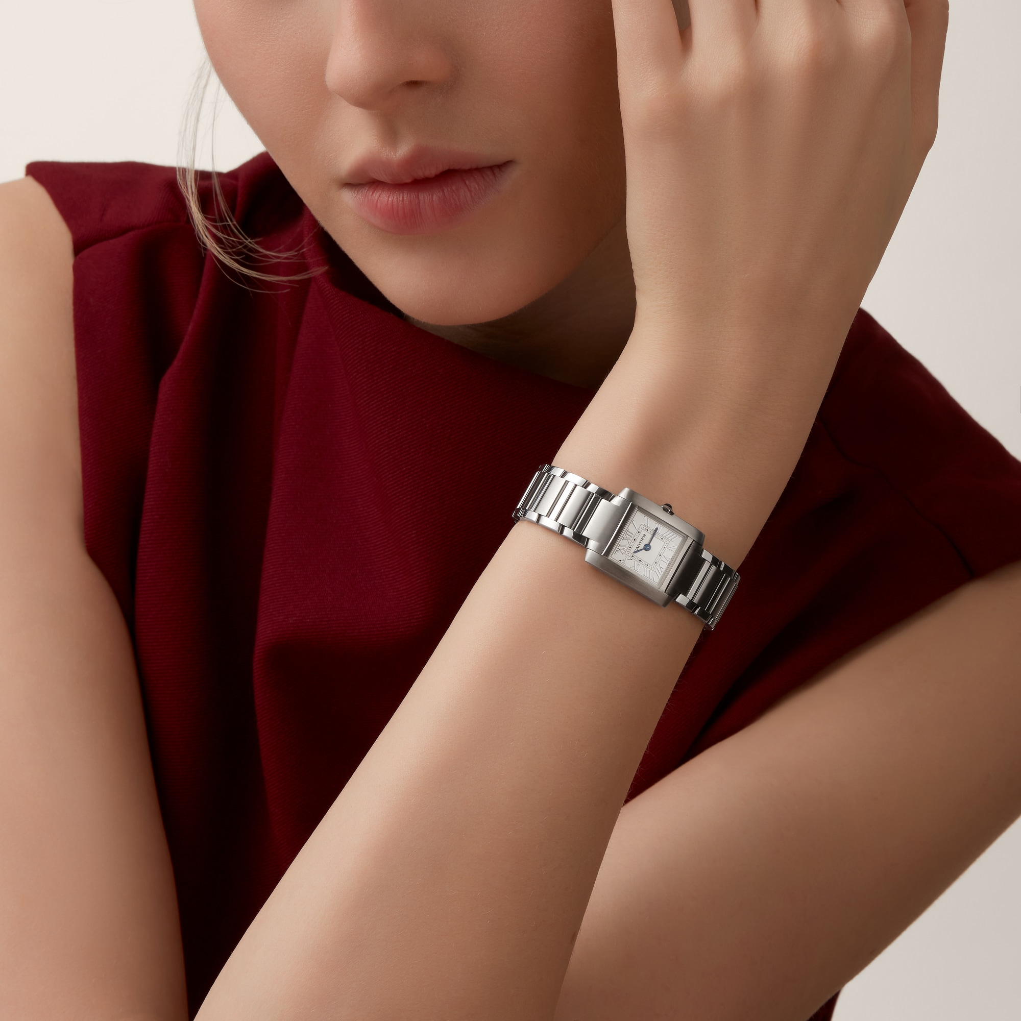 Woman's wrist showcasing the elegant small Tank Française dupe Cartier watch with a full steel design.