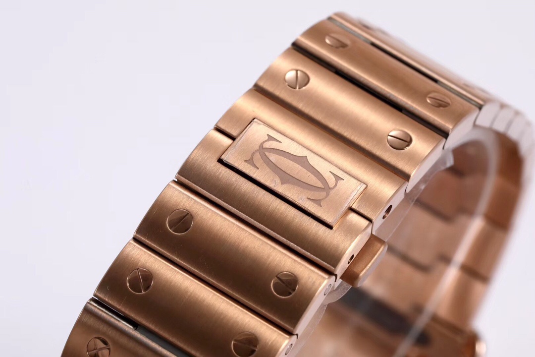 Close-up of the clasp on the BVF Super Clone Cartier Santos rose gold replica watch's steel bracelet, featuring the Cartier logo.