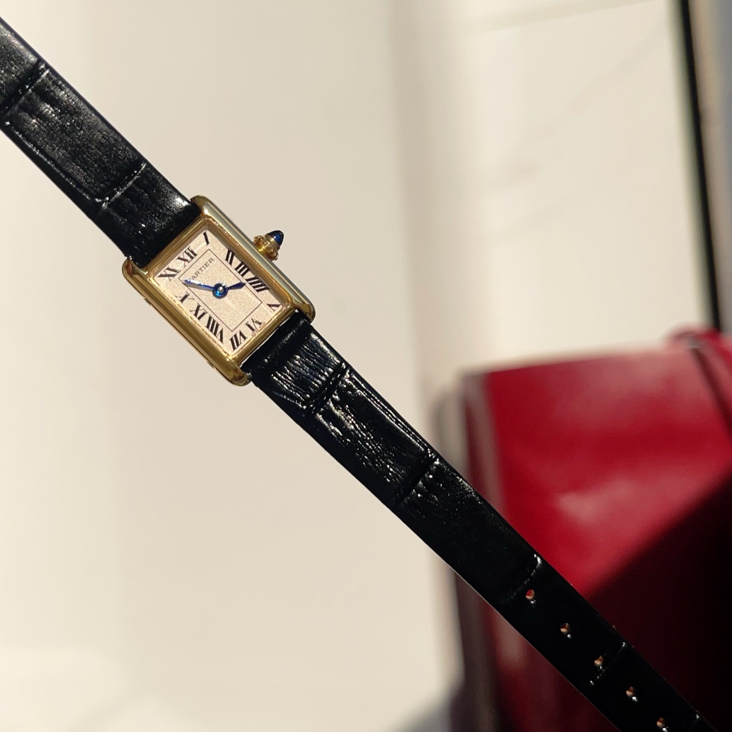 Full overhead view of the AF Super Clone Cartier Tank Louis replica watch, showing its compact dial and black leather strap.