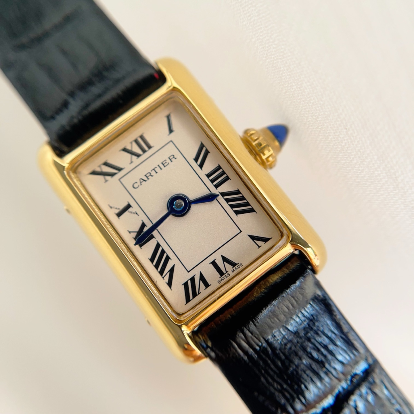 Front view of the AF Super Clone Cartier Tank Louis replica watch with a gold case, cream dial, and black leather strap.