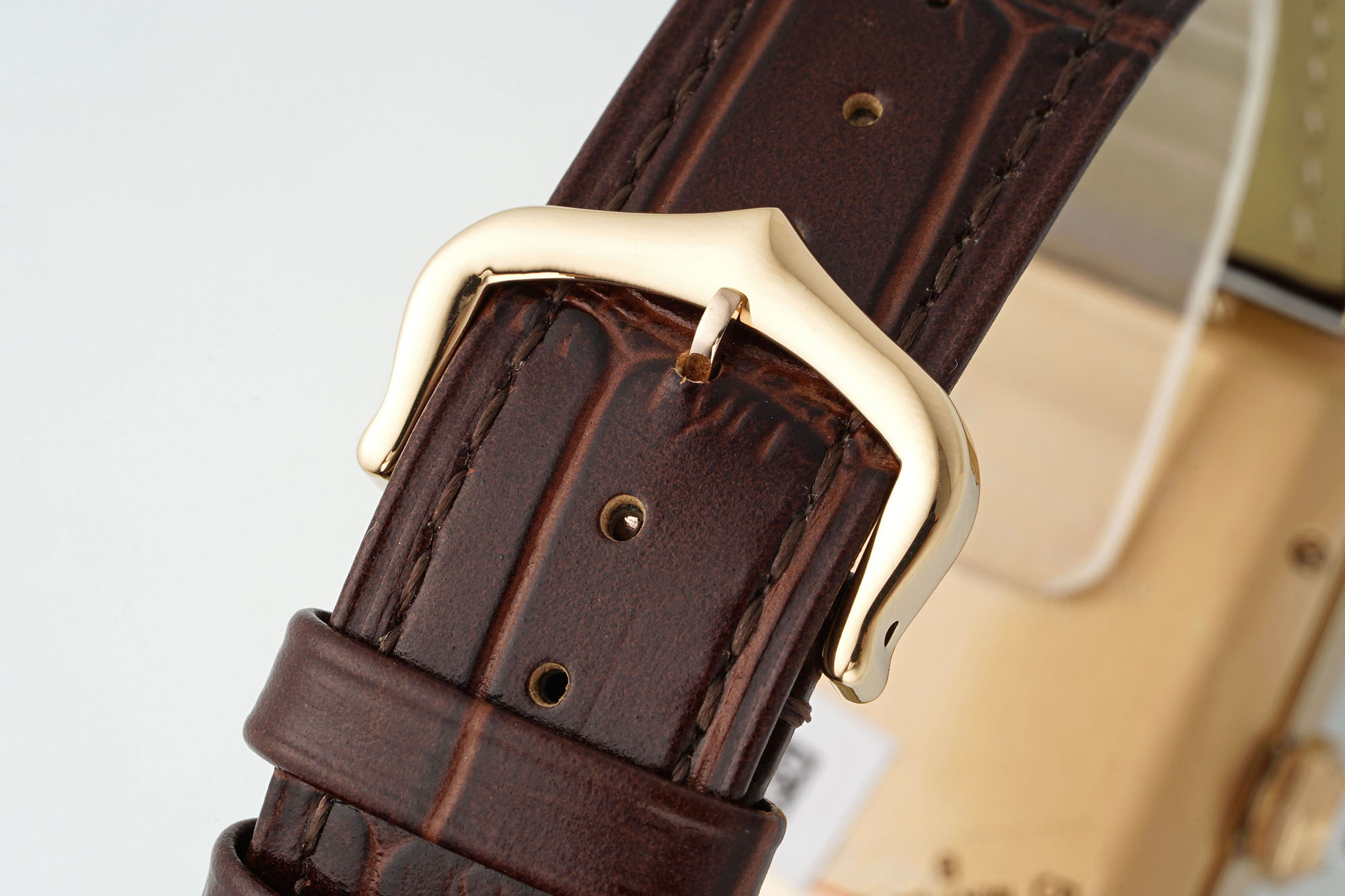 Close-up of the brown leather strap and rose gold pin buckle of the AF Super Clone Cartier Tank Américaine replica watch.
