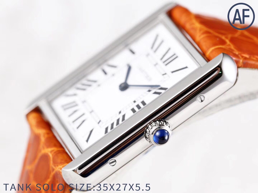Close-up side view of the crown on the AF Super Clone Cartier Tank Solo silver case replica watch, with its blue sapphire cabochon.